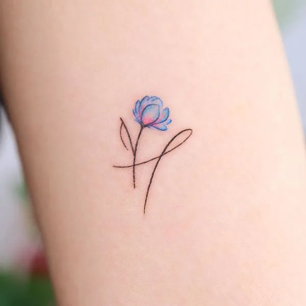 Small H and flower tattoo by @noul_tattoo