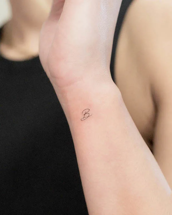 Tiny B initial wrist tattoo by @tivas