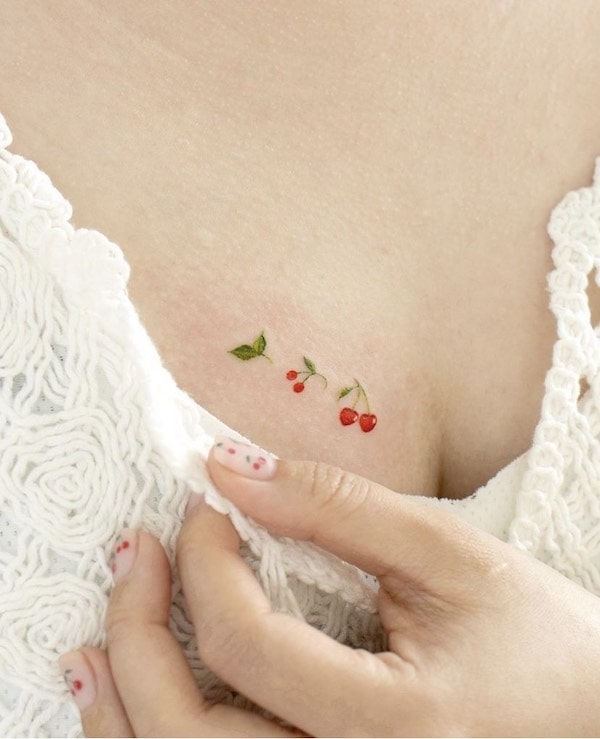 Tiny cherries tattoo by @ovenlee.tattoo