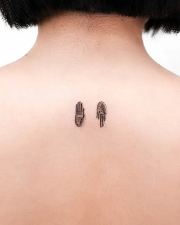 Tiny Buddha hands nape tattoo by @tattooist_kimria