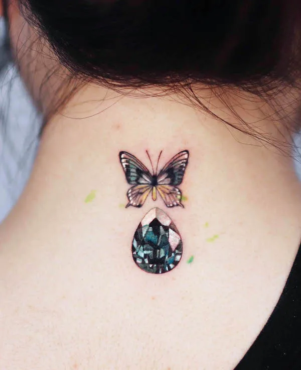 Butterfly and gemstone back tattoo by @studio_jaw