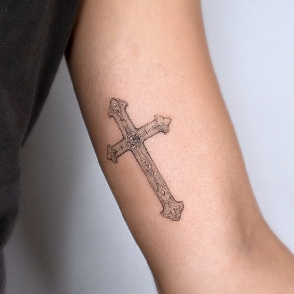 Vintage cross bicep tattoo by @choseung.tat
