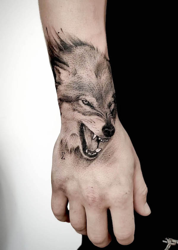 Fierce wolf hand tattoo by @rastislav.tattoo