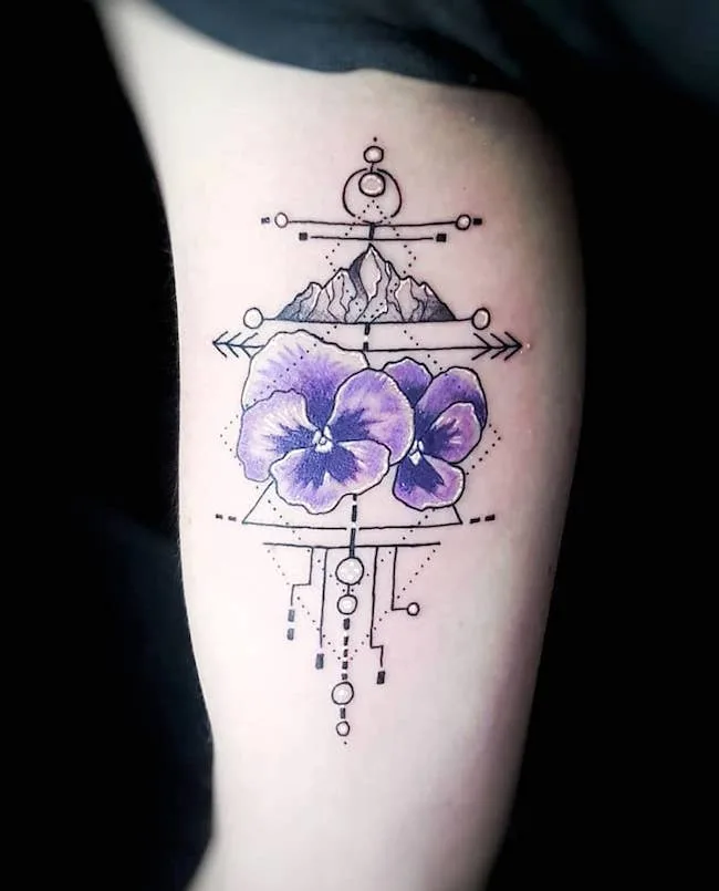 A Capricorn pansy arm tattoo by @livingprayertattoo