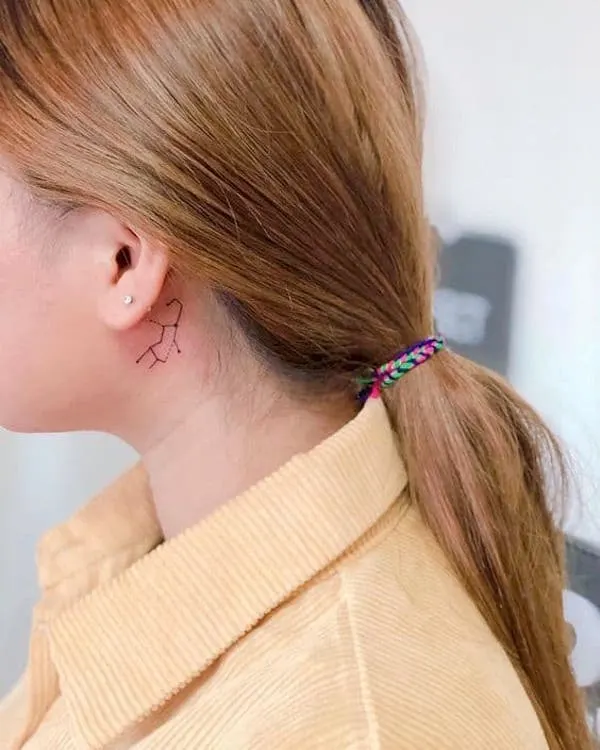 A Virgo constellation tattoo behind the ear by @mcqueen_mode