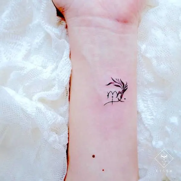 A Virgo symbol tattoo on the wrist by @kissa.tattoo