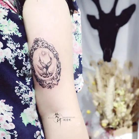 A creative Pisces tattoo with double fishtails by @tattoo_szs