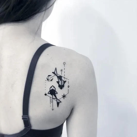 A cute geometric Pisces shoulder blade tattoo by @greemtattoo