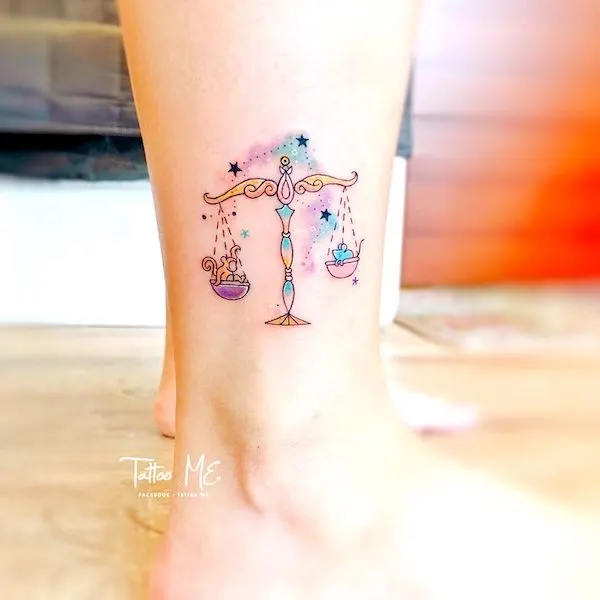 A delicate watercolor scale tattoo above the ankle by @deardeeri
