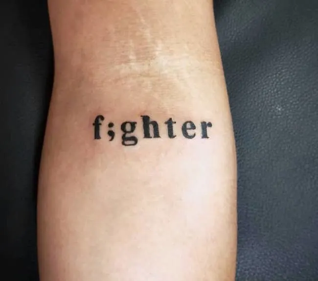 A fighter tattoo with a semicolon from @maia_ink_antonio