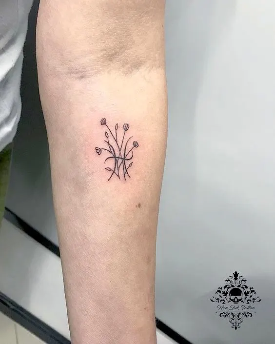 A floral Pisces symbol forearm tattoo by @urbiolatattoo