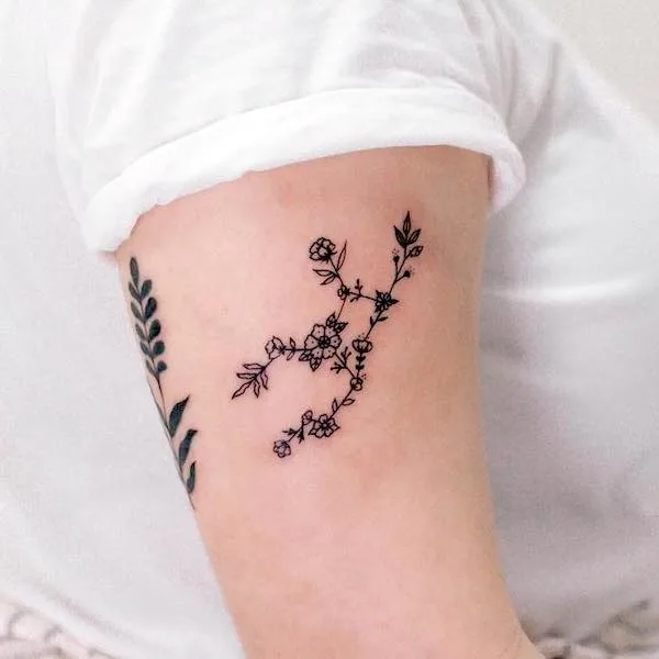 A floral Virgo constellation tattoos on the arm by @nuhfun