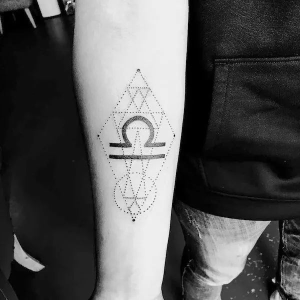 A geometric Libra sign symbol on the arm by @@deucetattoos