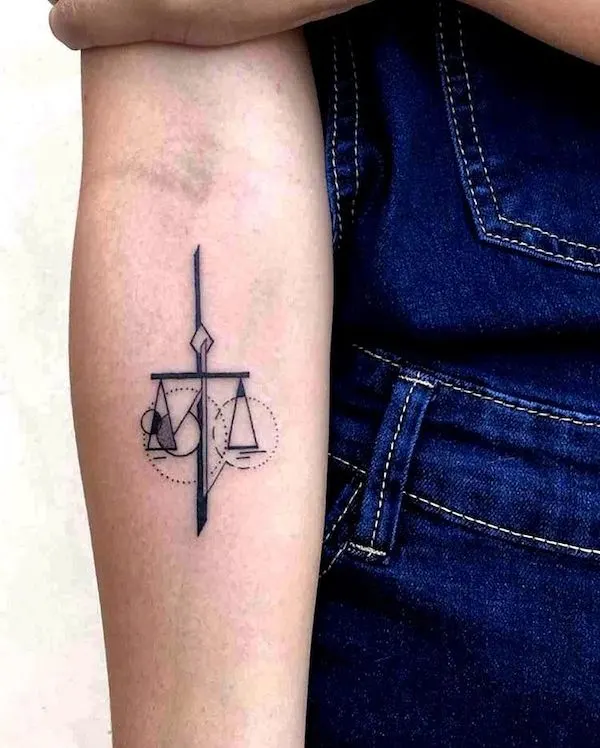 A geometric scale tattoo on the arm