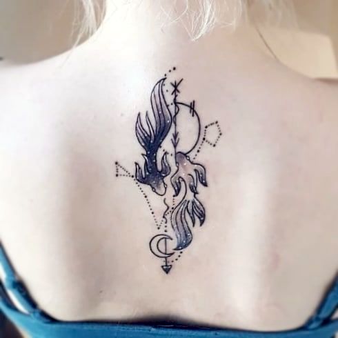A glittering back tattoo the Pisces symbol by @vanessa_kanaet_tattoo