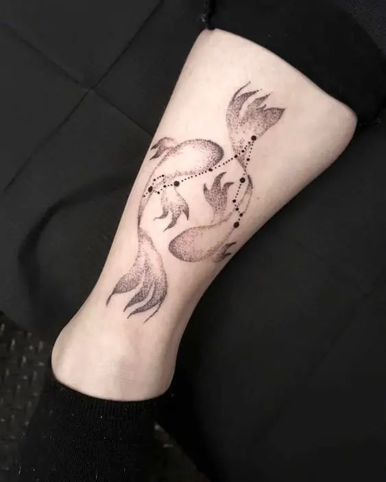 A gradient double fish calf tattoo with Pisces constellation by @studio_one_chemnitz_zentrum