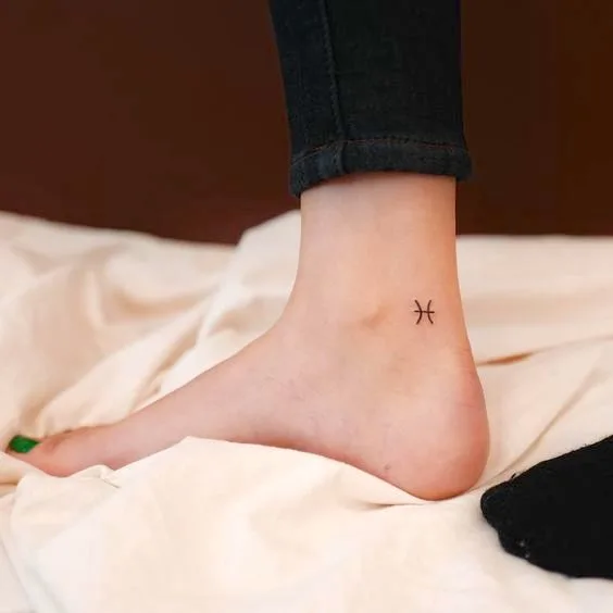 A minimalist astrology symbol tattoo on the ankle by @hansantattoo