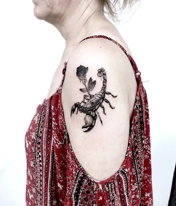 A realistic scorpion tattoo with rose by @gianinatattooer