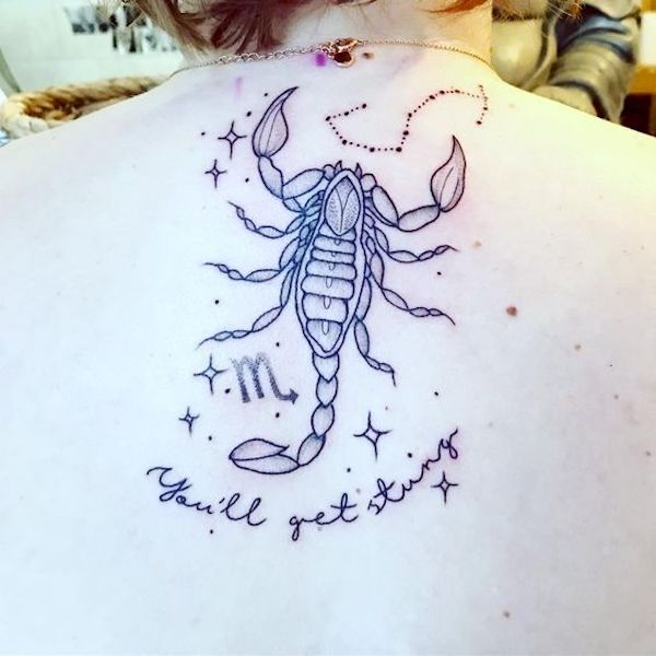 A scorpion tattoo with inspiring quotes by @charleylangston