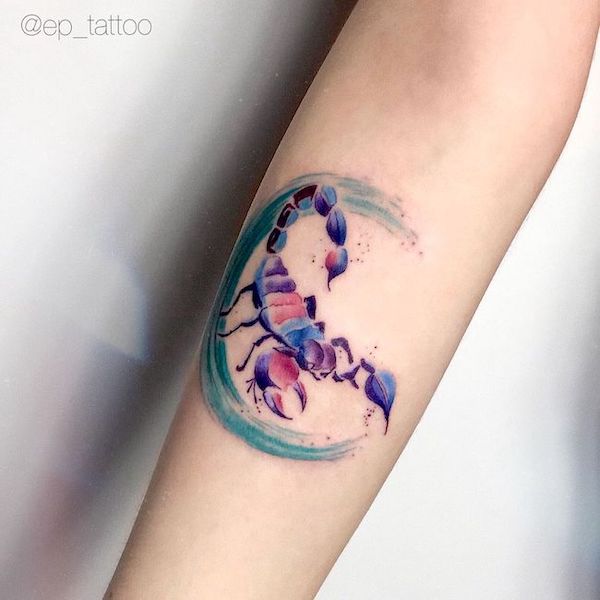 A watercolor Scorpio arm tattoo by @liza_vesna_tattoo