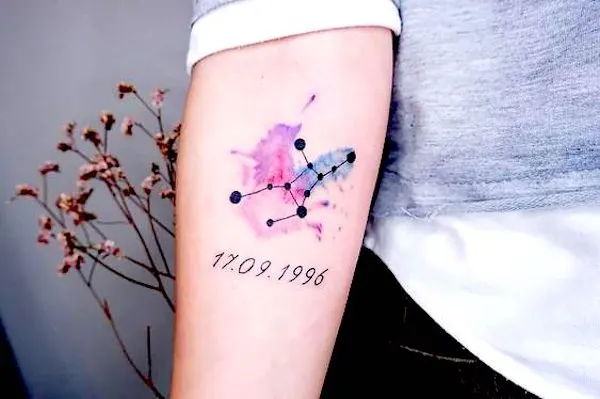 A watercolor tattoo with the date of birth by @tattooistxael