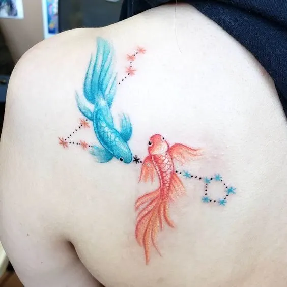 A watercolor yin yang tattoo on the shoulder blade by @jesmartintattoos
