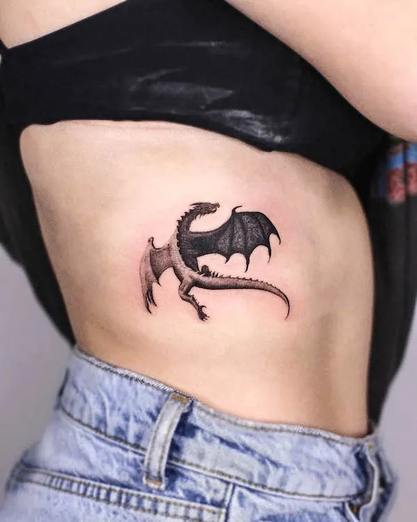 Black dragon rib tattoo for women by @inkbybailey