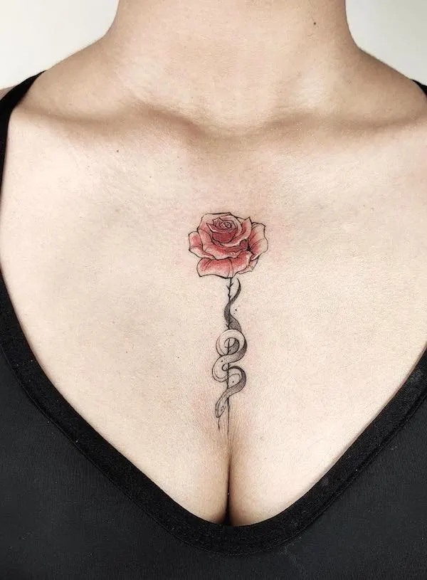 Elegant and simple snake and rose chest tattoo by @macy.tattoo