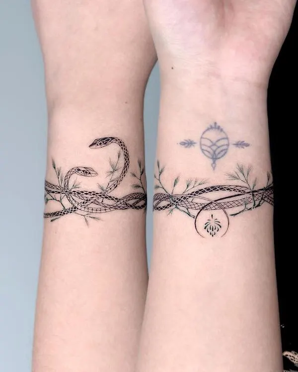 Matching snake bracelet wrist tattoos by @bium_tattoo