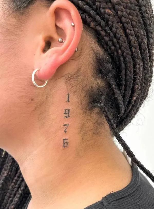 Fine line heart tattoo on the left side of the neck