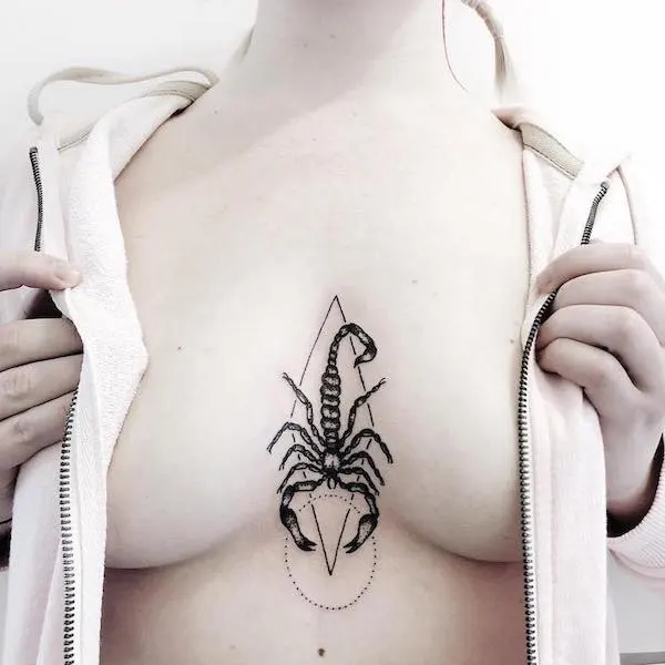 Scorpio blackwork tattoo between the boobs by @lucyeezytattooing