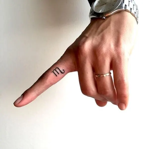 Scorpio symbol finger tattoo by @kinga_ink