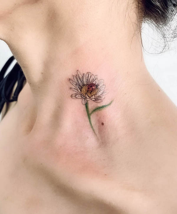 Small daisy on the side of the neck by @nur_tattoo_art