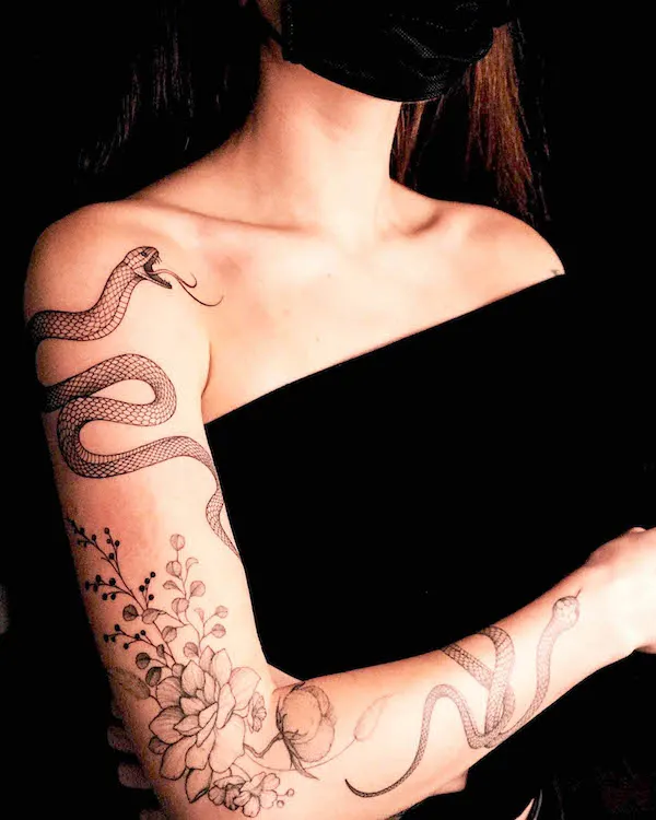 Snake and flower sleeve tattoo for women by @vlada.2wnt2