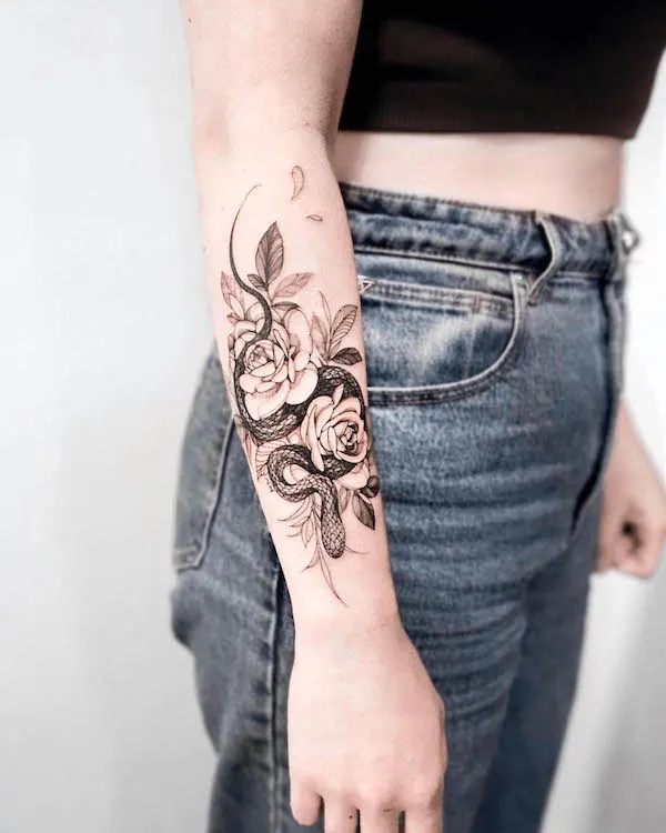 Snake and rose arm tattoo by @goyotattooart