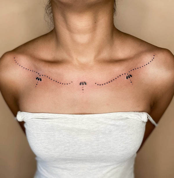 Tassel and lace ornamental collarbone tattoo by @border.line_.tattoos