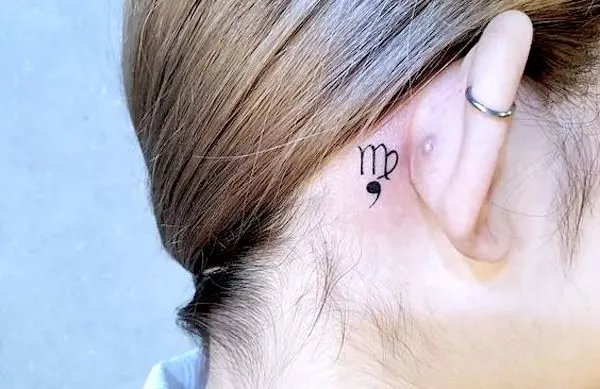 Tiny ear back Virgo symbol tattoo by @peria_tattoo