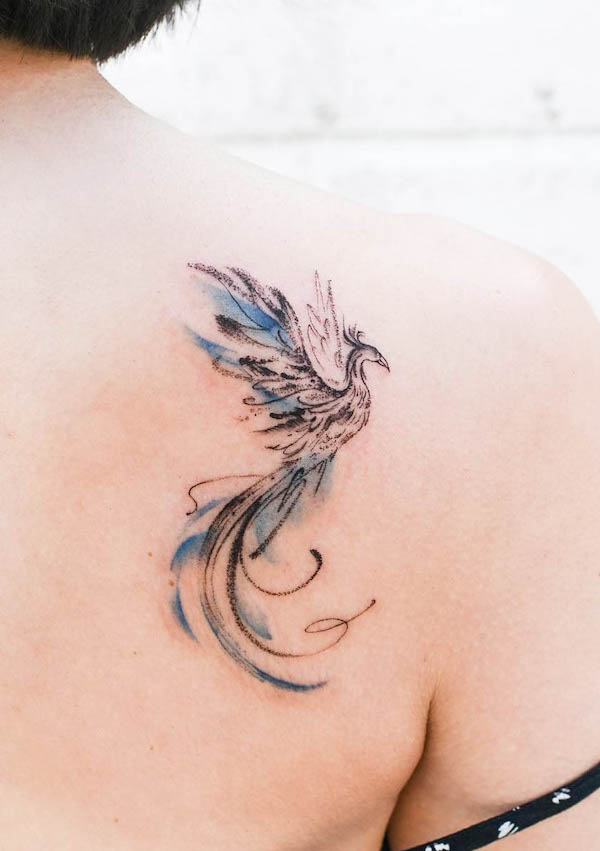 Small watercolor phoenix on the shoulder blade by @joytattoo_