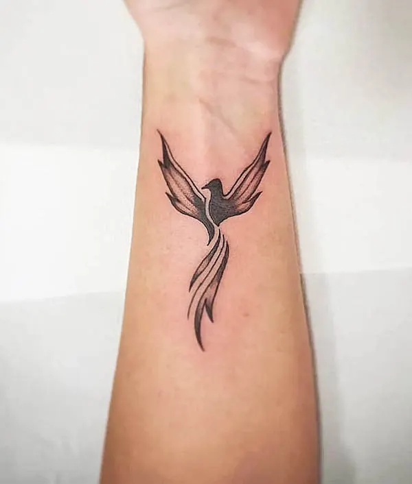 Black phoenix wrist tattoo by @mmarcadini
