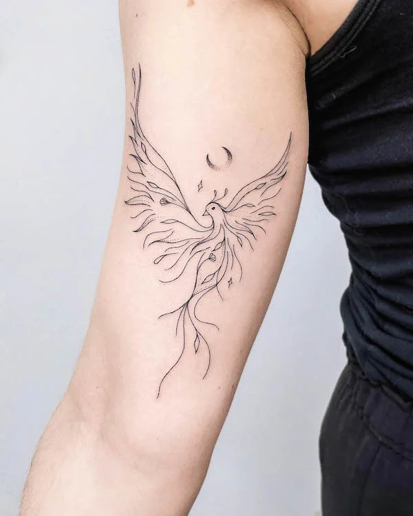 Sleek fine line phoenix arm tattoo by @nothingwildtattoo