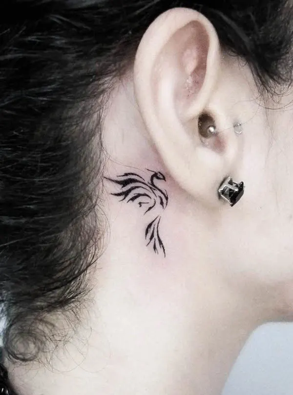 Small phoenix behind the ear tattoo by @oztattoom
