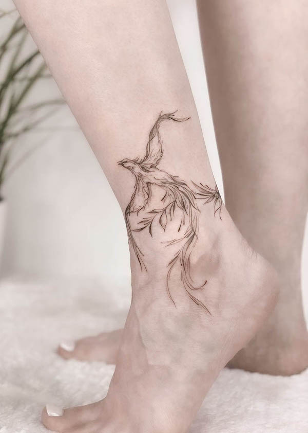 Wrap-around-the-ankle phoenix tattoo by @shvetstattooing