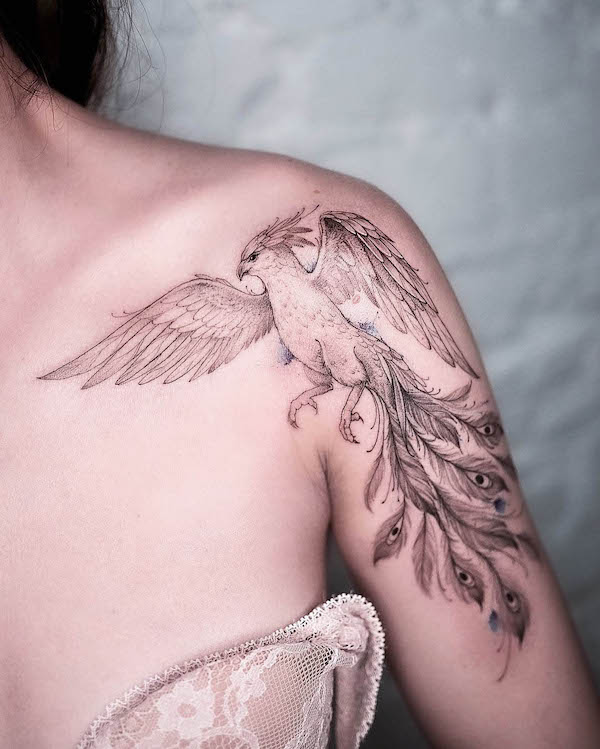 Intricate phoenix shoulder tattoo by @solovyovatattooer