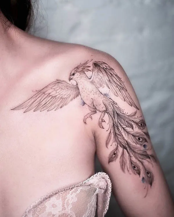 Intricate phoenix shoulder tattoo by @solovyovatattooer