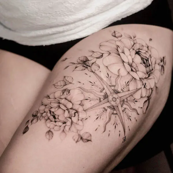Compass and flowers thigh tattoo by @dnq.tattoo