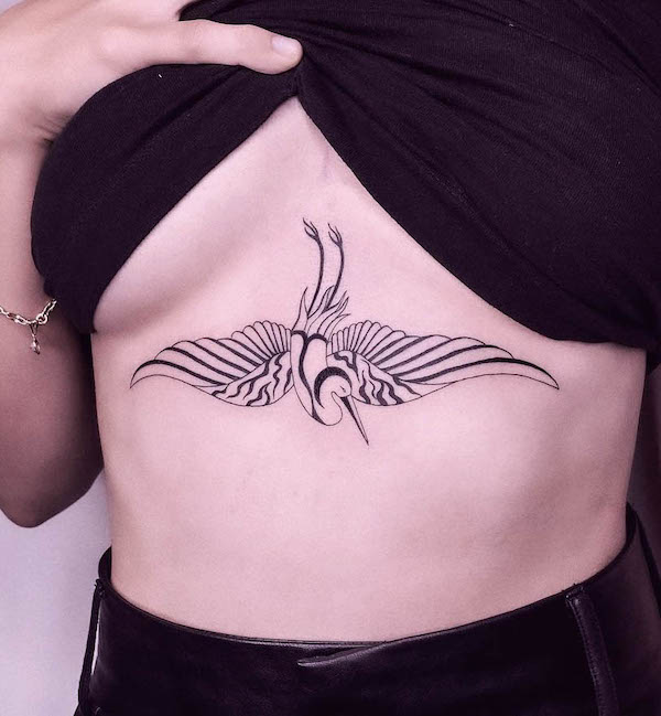 Crane tattoo on the sternum by @saskiapatrice