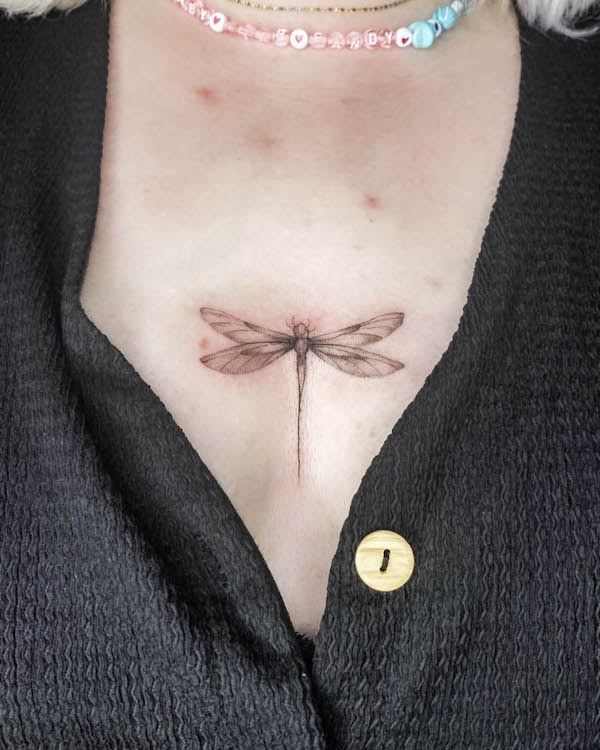 Dragonfly tattoo between boobs by @colette.ink_