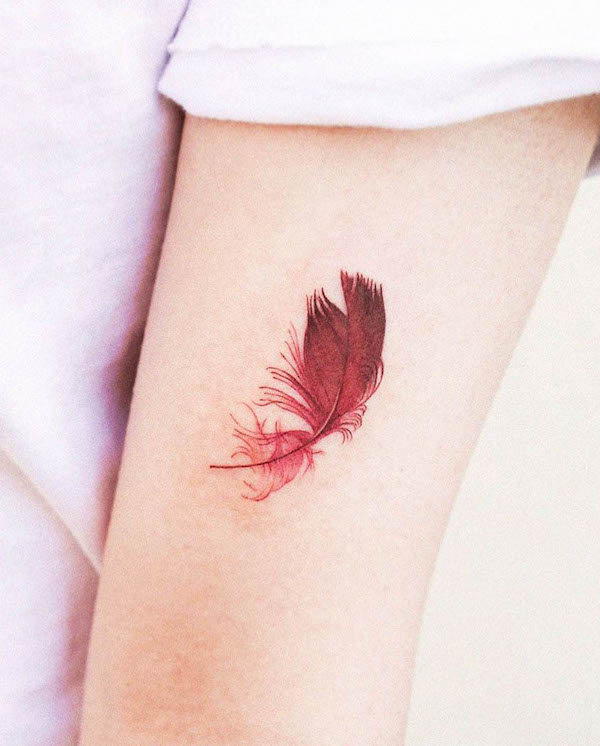 Red feather tattoo by @hansantattoo