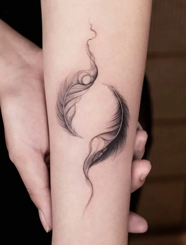 Yin and yang feathers on the forearm  by @ink.feb24