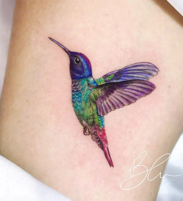 Rainbow color hummingbird tattoo by @blu.tattoo